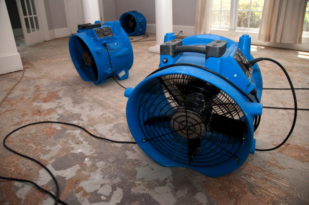 Air movers drying equipment set up after storm flooding in a Pinellas County home.